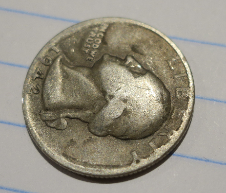 1942-Quarter-Capped-Die?-Damage?-Or-Something-Else.